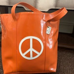 Two-toned, Anne-Charlotte Goutal Paris peace sign tote.